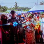 TmMrs Tobore Oborevwori cutting the tape to inaugurate the cottage hospital