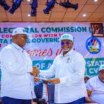 Delta Dep Gov, Monday Onyeme in a handshake with  Delta REC, Sir Etekamba Udoh Umoren during the occasion