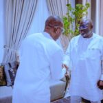 Gov Sheriff in a handshake  with the celebrant