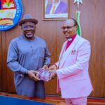 Gov Sheriff receiving a gift from Archbishop Solomon Gbakara during the visit